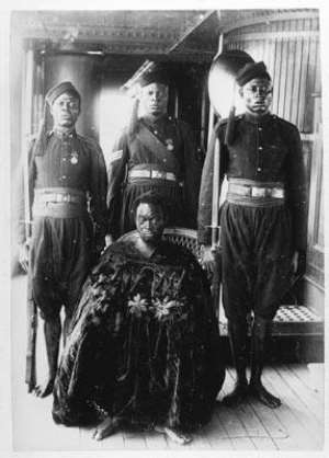 Photograph by the Ibani Ijo photographer J A Green. Oba Ovonramwen with guards on board ship on his way to exile in Calabar in 1897.
